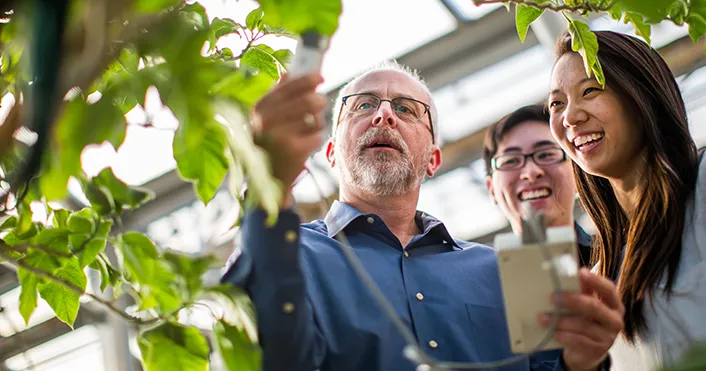 Kevin Lee Griffin with students and plants.